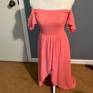 A cute dress with shorts underneath with an open back and Hilow features